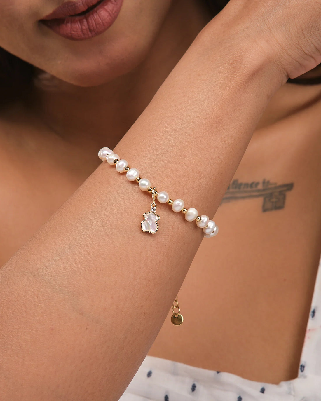 Refined Layers by Chandrani Pearls: This stackable bracelet features lustrous pearls, gold accents, and a teddy bear-shaped charm, creating a charming sea-inspired accessory for any ocean jewelry collection.