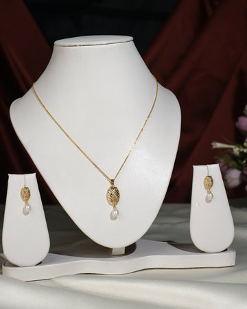The Pretty Pendant Set by Chandrani Pearls India features elegant leaf-shaped pendants with pearl drops, styled on a white jewelry stand—an exquisite choice to enhance any ensemble. (Chain used for photographic purpose.).
