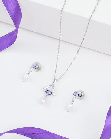 Chandrani Pearls Vintage Bloom Pendant Set: 925 silver necklace and earrings with CZ detailing, purple gemstones, and dangling white pearls, shown on white with a purple ribbon.