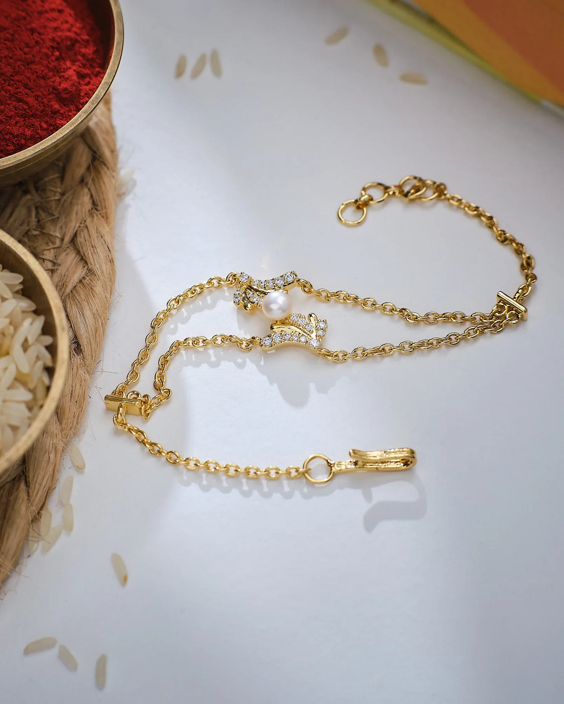 A close-up of a person in a yellow textured sleeve wearing the Glow Mode Pearl Bracelet by Chandrani Pearls, featuring delicate pearls, subtle decorative accents, and a touch of stone-studded elegance.