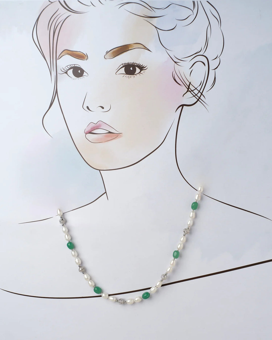 The Rasvatta - The Olive Elegance Pearls And Beads Necklace by Chandrani Pearls, showcasing alternating white pearls, green beads, and silver accents, elegantly rests on a purple surface with a pink edge.
