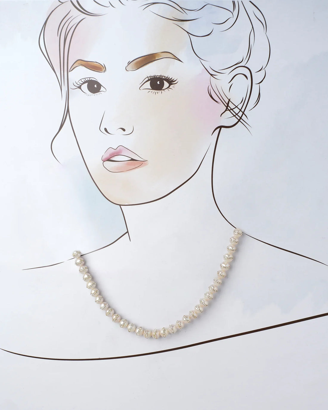 The Velakula-The Coastline Stories Pearl Necklace by Chandrani Pearls, featuring gold and crystal spacer beads, is elegantly showcased on a purple surface.