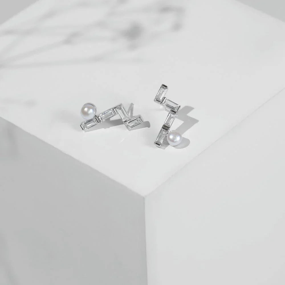 Chandrani Pearls' Minimalist Pearl & CZ Studs feature rectangular cubic zirconia in a zigzag design, each accented with a round freshwater pearl.