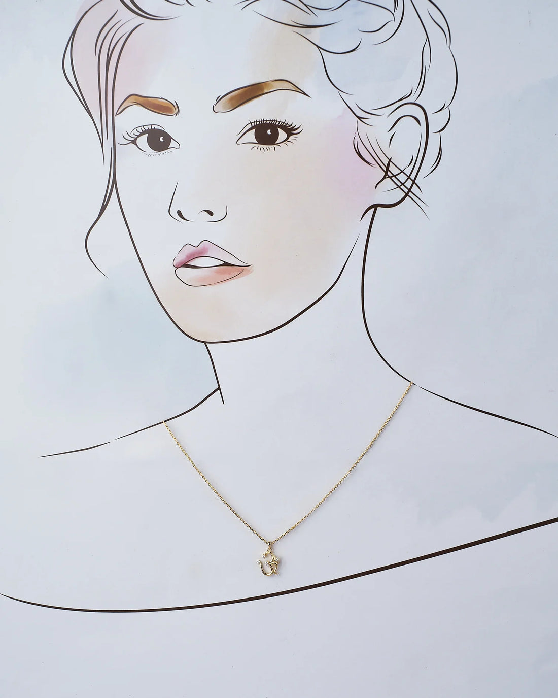 The OM 925 Silver Pendant by Chandrani Pearls India, featuring a chic "Om" design with clear stones, displayed on a pink surface near red roses, is a stylish accessory that elevates your look.