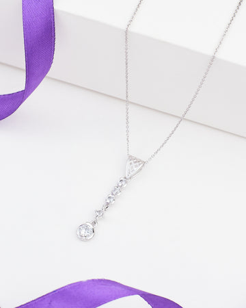 The Demifine Grace Pendant 925 Silver with CZ Sparkle by Chandrani Pearls features a row of clear gemstones and a round crystal, shown on a white background with a purple ribbon—an elegant choice for any occasion.
