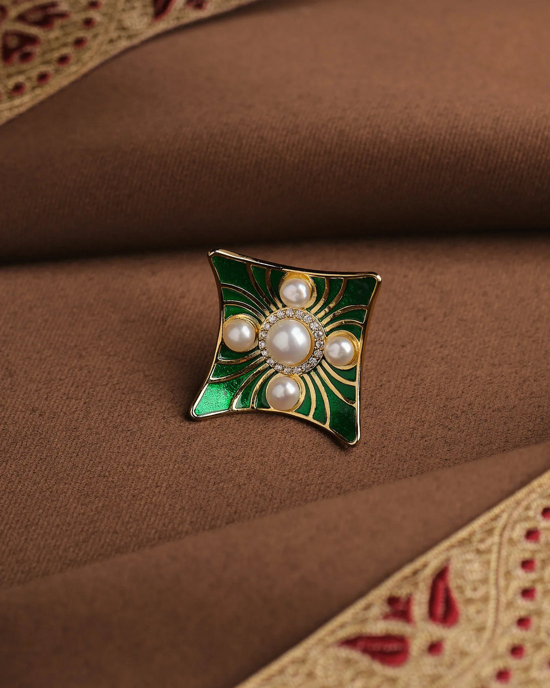 The Rectangle-Inspired Pearl Ring with Filigree Detailing by Chandrani Pearls features five pearl accents and an antique-inspired design, making it a standout piece for elegant occasions.