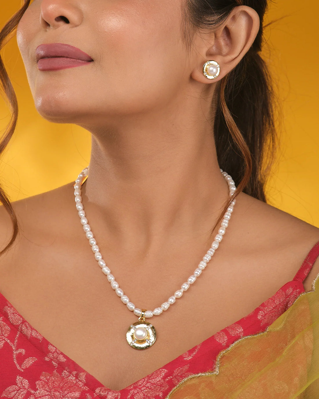 The Princess-Cut CZ Necklace Set by Chandrani Pearls is displayed on a navy blue stand, featuring a sparkling pendant and matching earrings for a bold, modern jewelry statement.