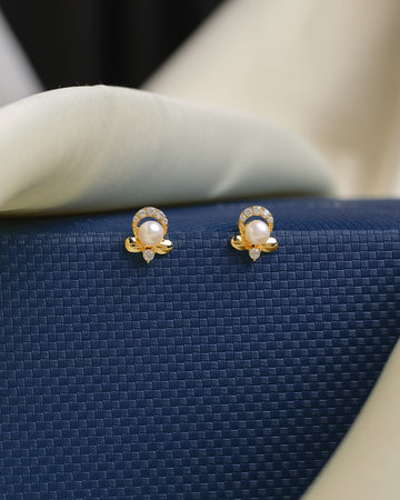 Chandrani Pearls' Pretty Pearl Stud earrings feature central pearls, sparkling CZ stones, and a leaf-shaped detail—ideal for adding graceful elegance to your wedding dress or evening gown.