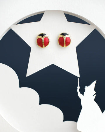 Chandrani Pearls India's Cute Stud Earrings feature a red and black round design on a white star-shaped cutout, complete with a casting figure silhouette at the bottom.