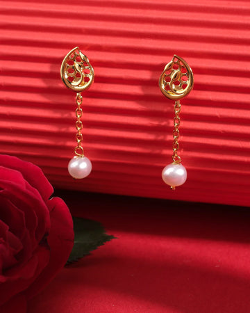 Tulipia 925 Silver Earrings by Chandrani Pearls with pearl drops in front of a red textured backdrop, paired with a red rose.