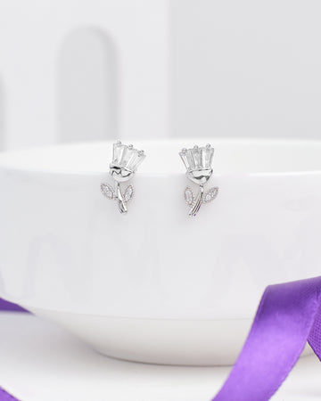 The Brunch Bloom CZ Silver Earrings by Chandrani Pearls feature flower-shaped silver designs with baguette-cut stones and leaf accents—ideal for adding a romantic touch to your casual weekend look.