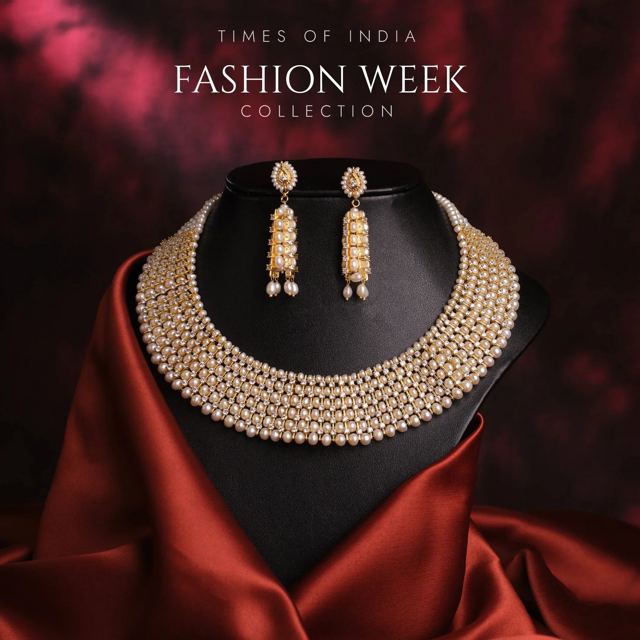 A pearl and gold necklace with matching earrings is displayed on a black stand, draped with red satin fabric. Text reads "Times of India Fashion Week Collection.