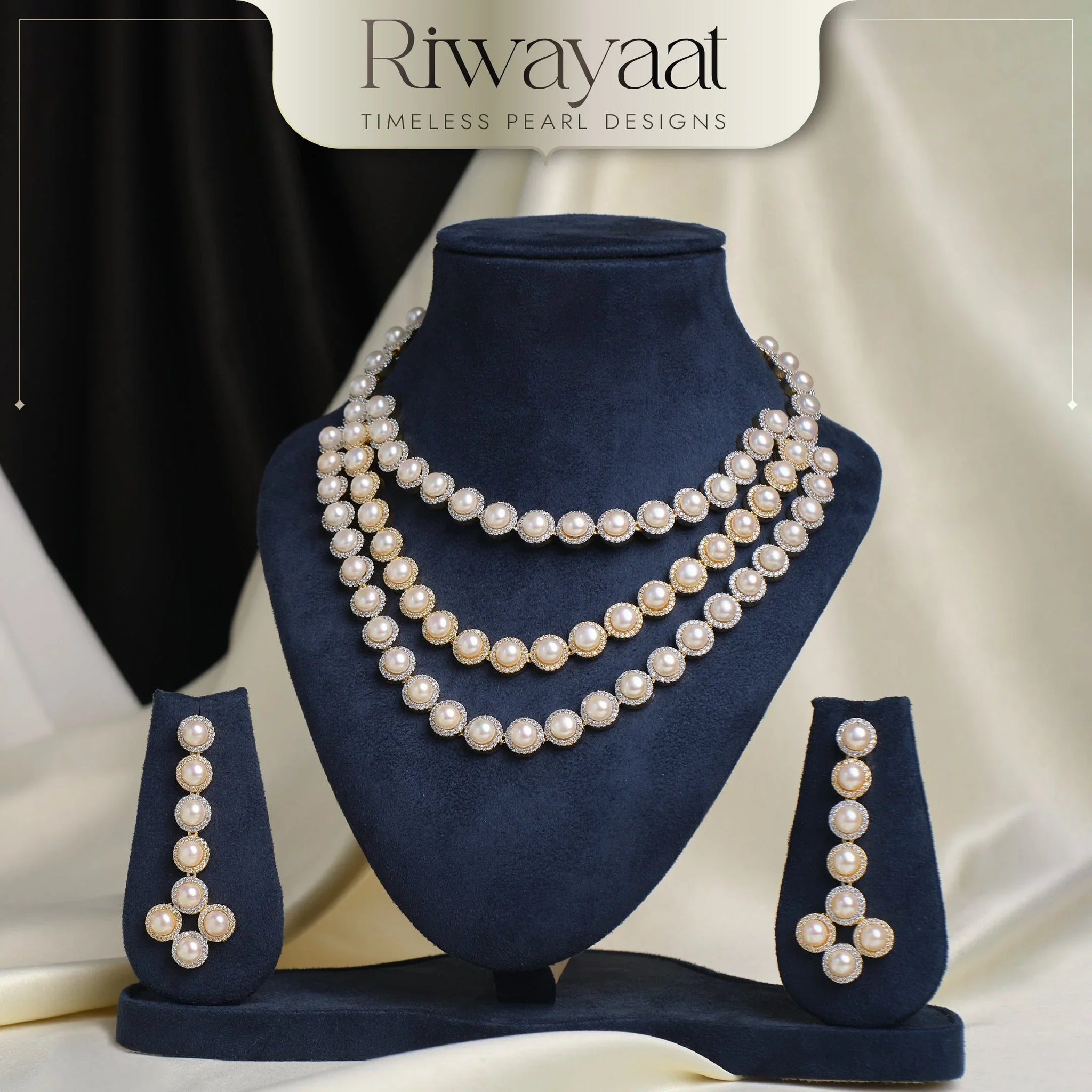 A pearl necklace set with matching earrings displayed on a navy blue stand, with the brand name "Riwayaat" at the top.
