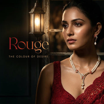 A woman in a red dress and pearl jewelry stands near a lantern. Text on the image reads: "Rouge: The Colour of Desire.