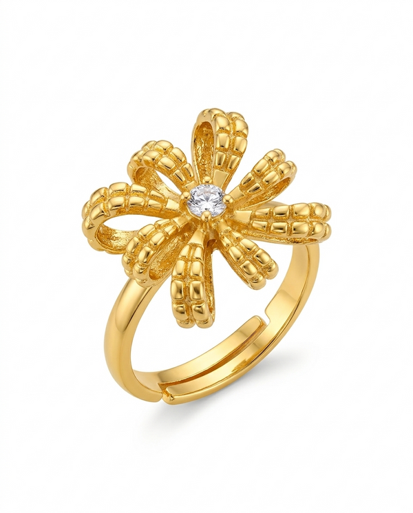 Gold flower-shaped ring with a diamond on a white background