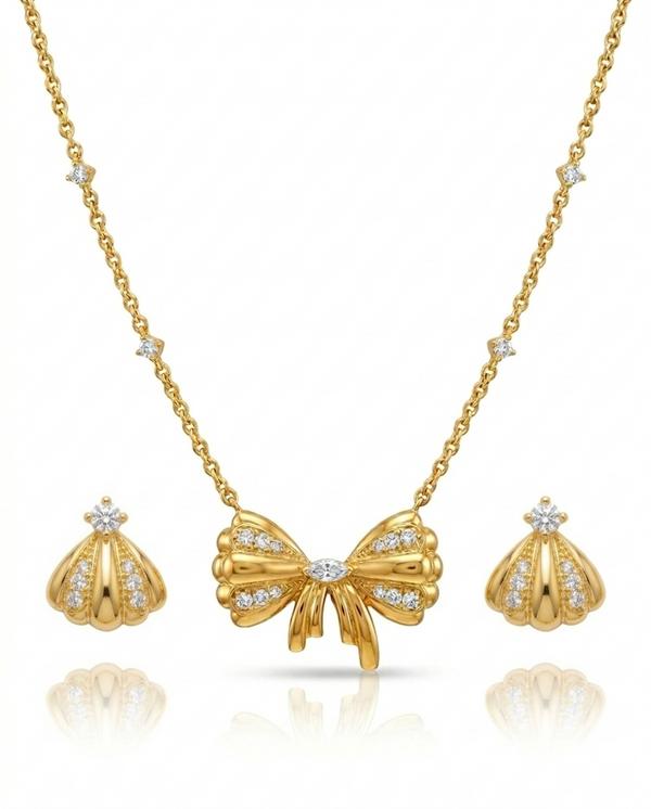 Gold bow necklace with matching earrings on a white background