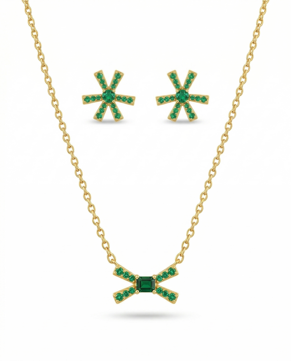 Jewelry set with necklace and earrings featuring green gemstones on a white background