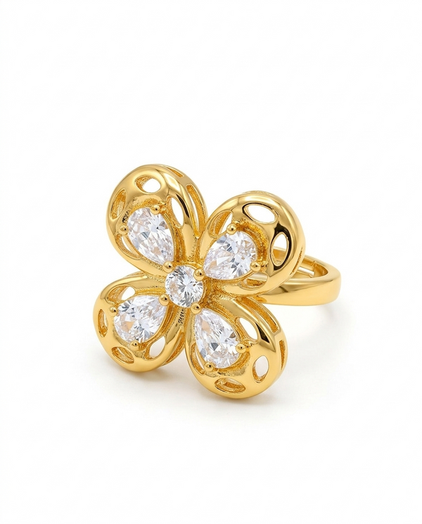 Gold flower-shaped ring with diamonds on a white background