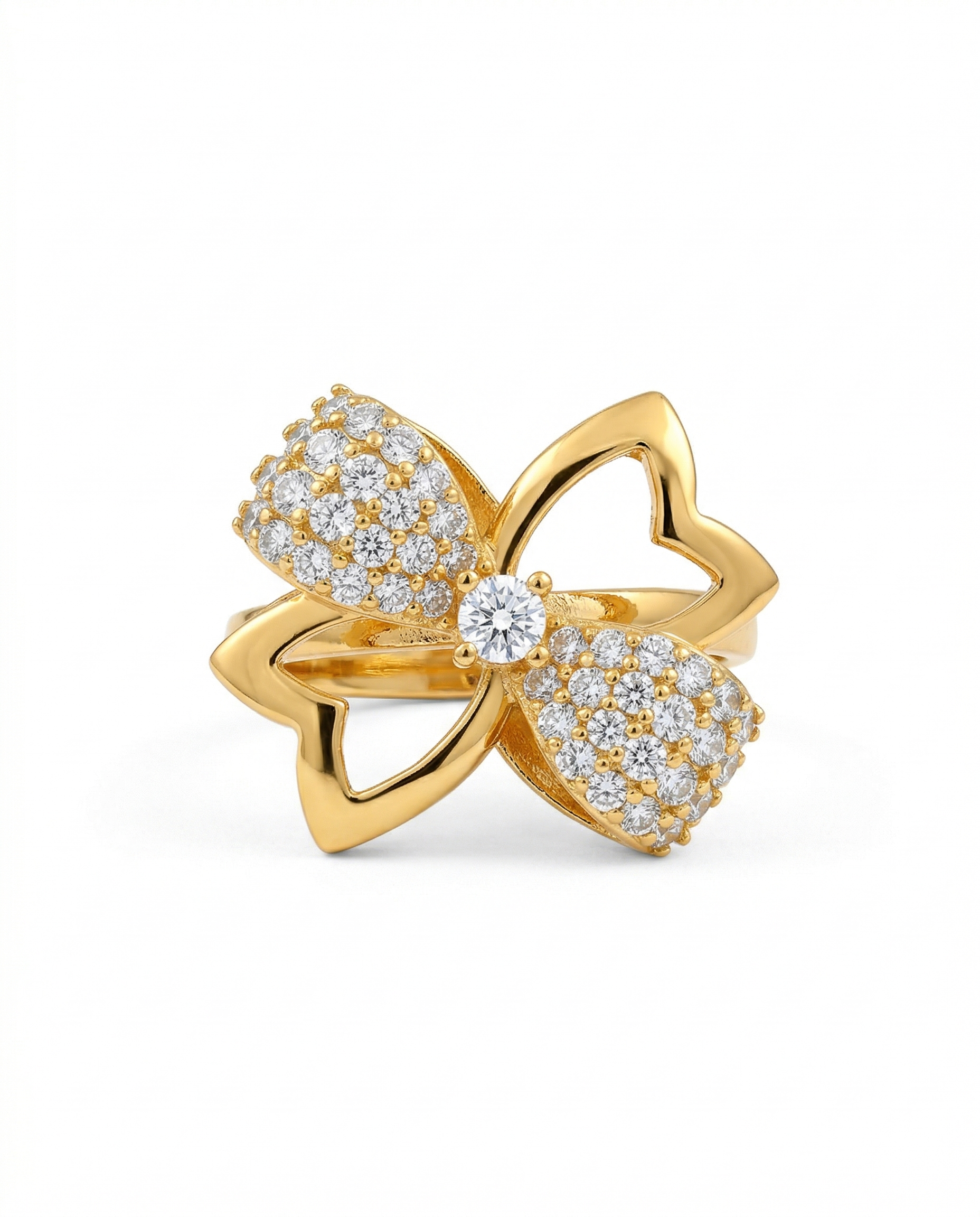 Gold bow-shaped ring with embedded diamonds on a white background