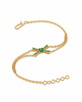 Gold bracelet with green gemstones on a white background