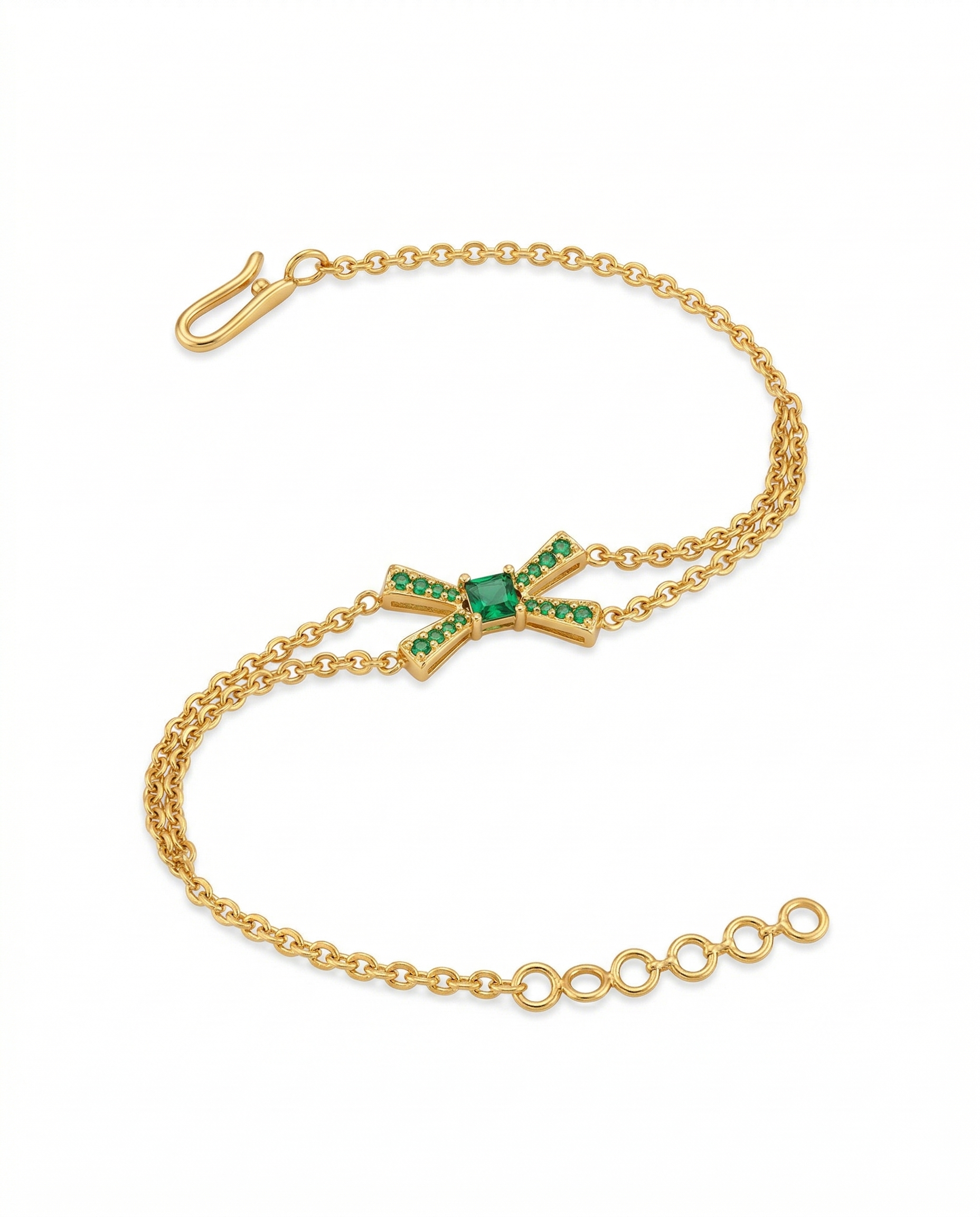 Gold bracelet with green gemstones on a white background