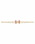 Gold bracelet with a bow-shaped clasp on a white background