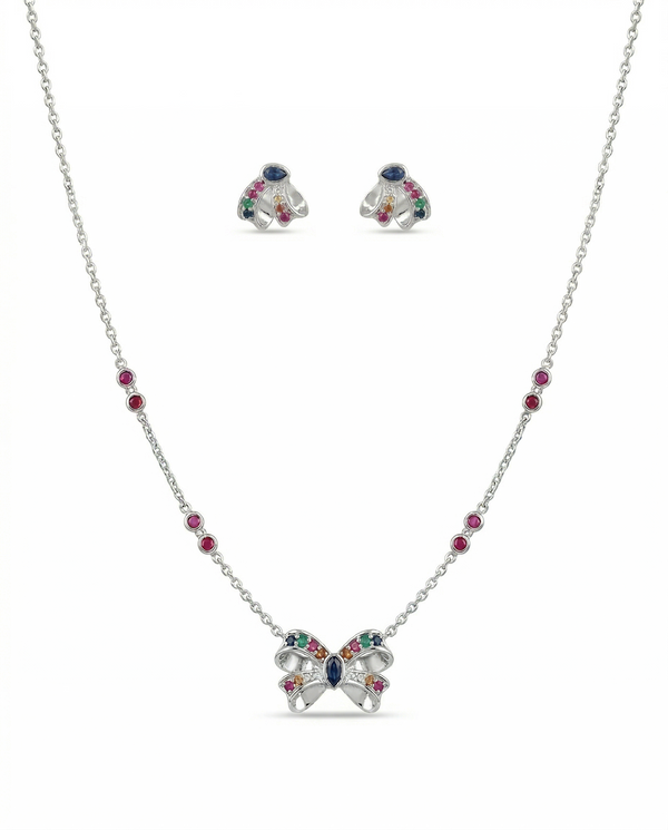Butterfly-shaped necklace and earrings with gemstones on a white background