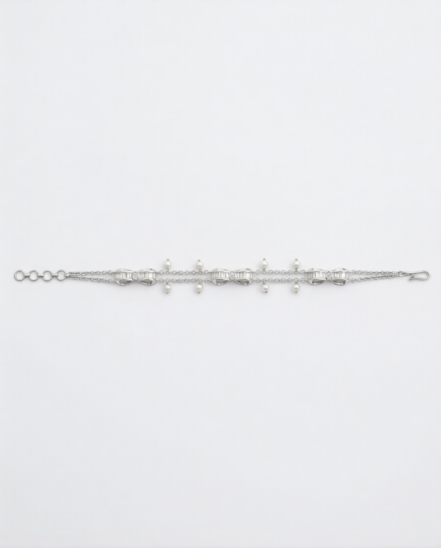 Silver bracelet with small beads on a light gray background