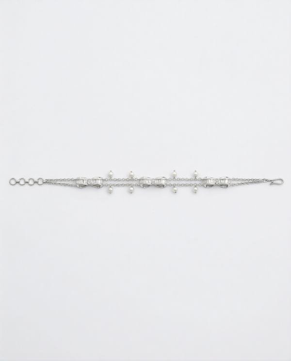 Silver bracelet with small beads on a light gray background