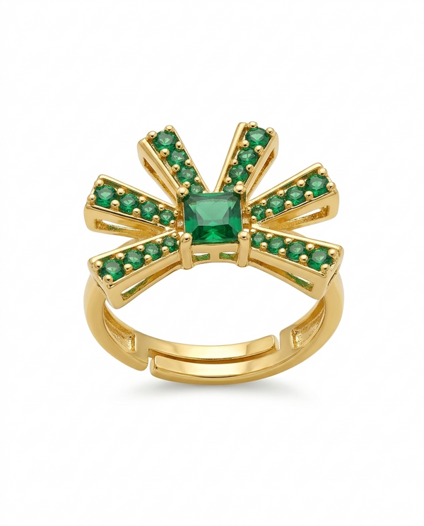 Gold ring with green gemstones on a white background