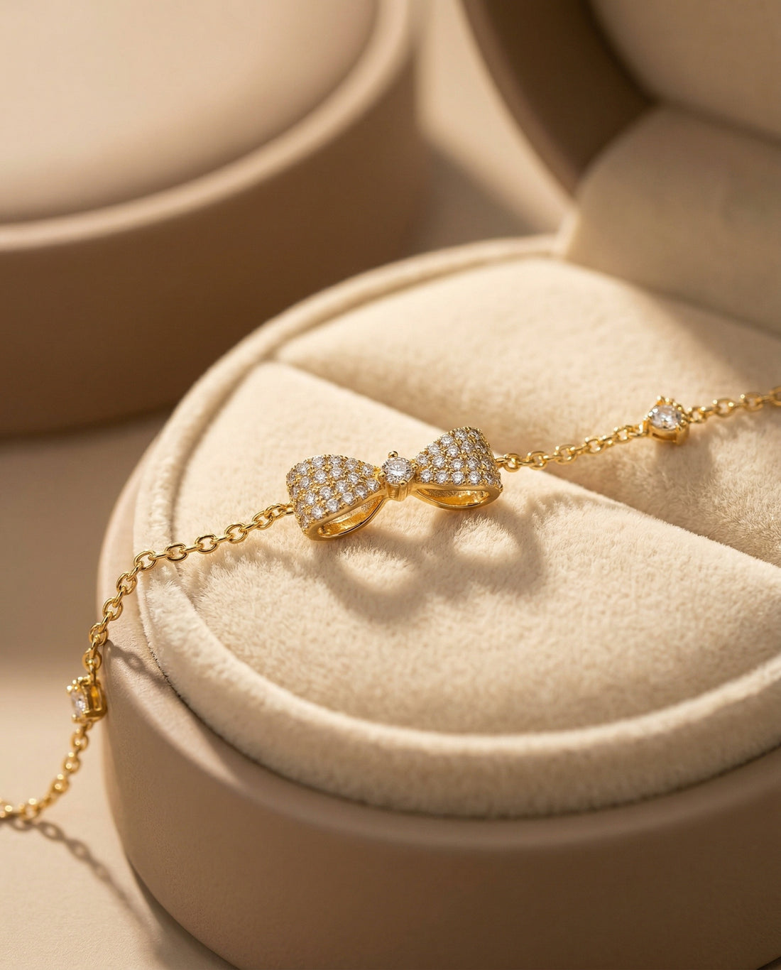 Gold bracelet with heart-shaped clasp on a white background