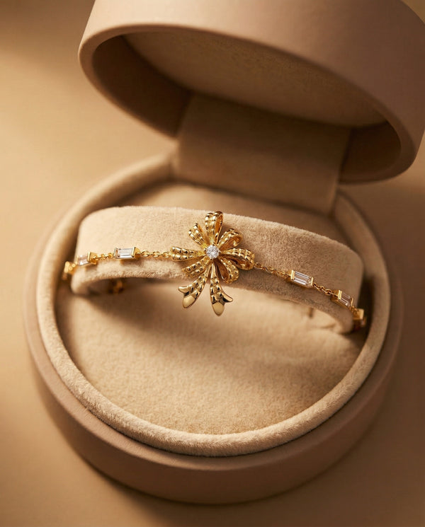 Gold bracelet with floral design in a jewelry box
