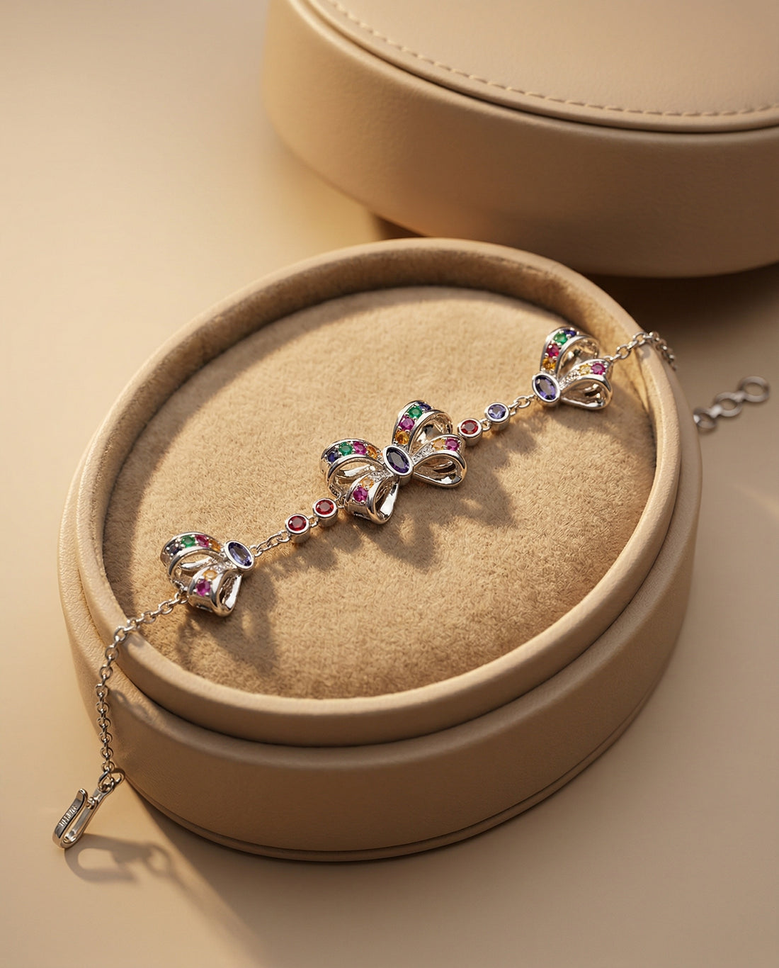 Silver bracelet with heart-shaped charms on a white background