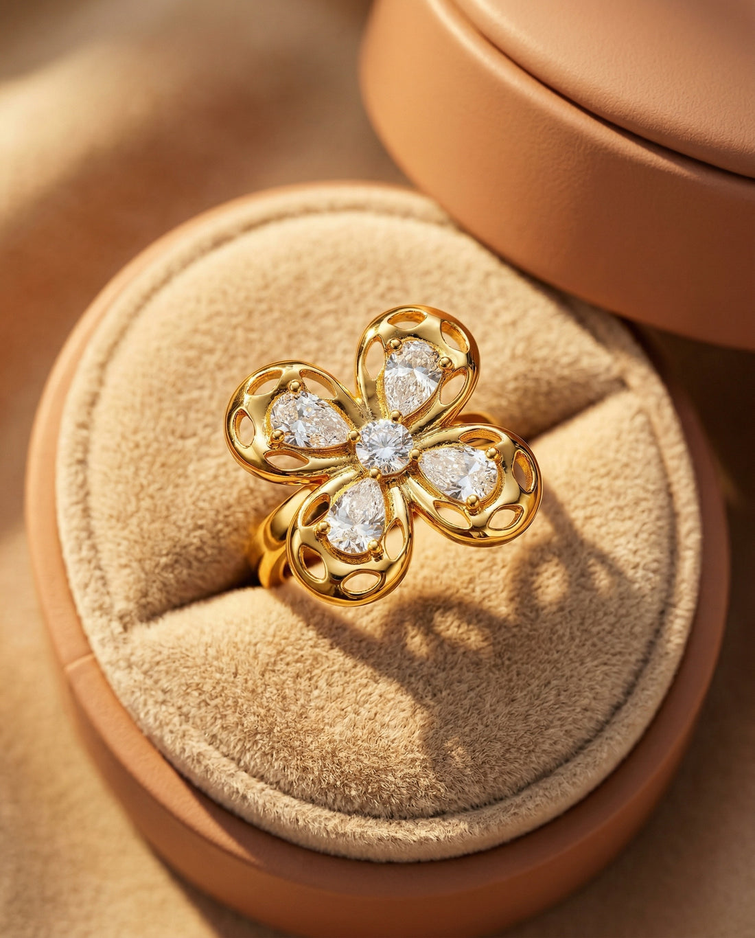 Gold flower-shaped ring with diamonds on a white background