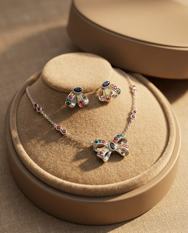 Butterfly necklace and earrings set on a brown jewelry display