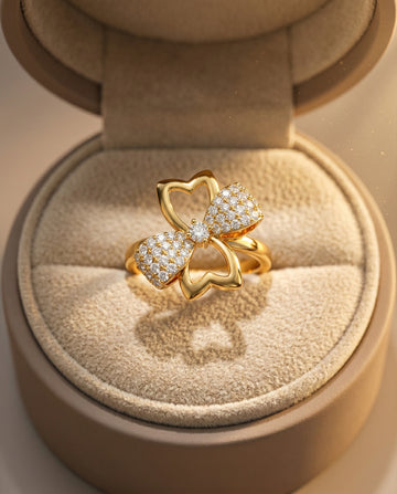 Gold ring with bow design in a jewelry box