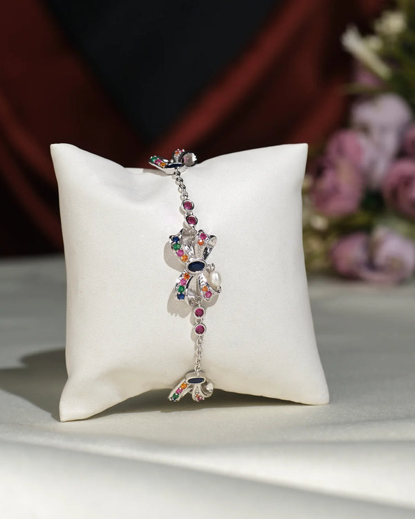 The Trendy Metallic CZ Pretty Bracelet by Chandrani Pearls India, shown on a white pillow against a burgundy backdrop, adds effortless charm to both casual outings and formal events.