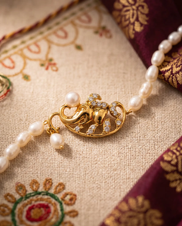 Gold-Plated Lord Ganesha Pearl Rakhi Cum Bracelet