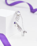 The Chandrani Pearls Luxury Tennis Bracelet in Sterling Silver with CZ Stones is showcased on a white block, accented by a purple ribbon in the background.