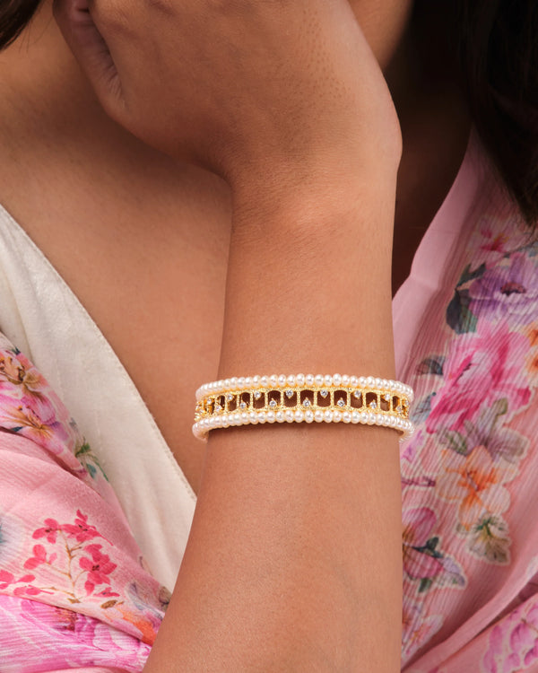 Elegant Gold Bangle with Double Rows of Pearls and Sparkling Stones