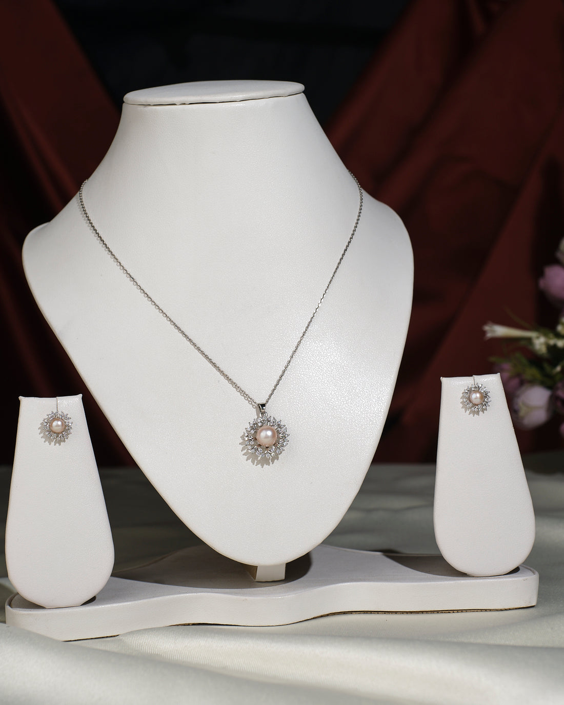 The Trendy Pendant Set by Chandrani Pearls India, shown with matching earrings on a white stand (chain for photography only), is perfect for adding a touch of luxury to your daily style.