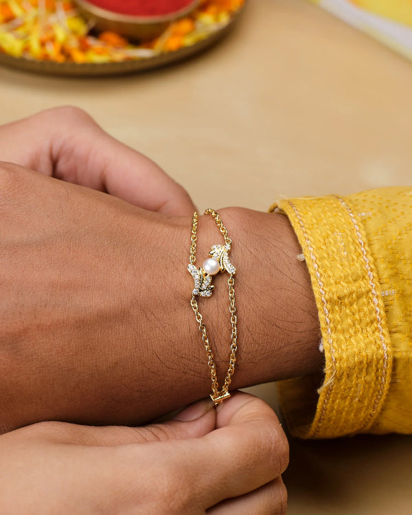 A close-up of a person in a yellow textured sleeve wearing the Glow Mode Pearl Bracelet by Chandrani Pearls, featuring delicate pearls, subtle decorative accents, and a touch of stone-studded elegance.