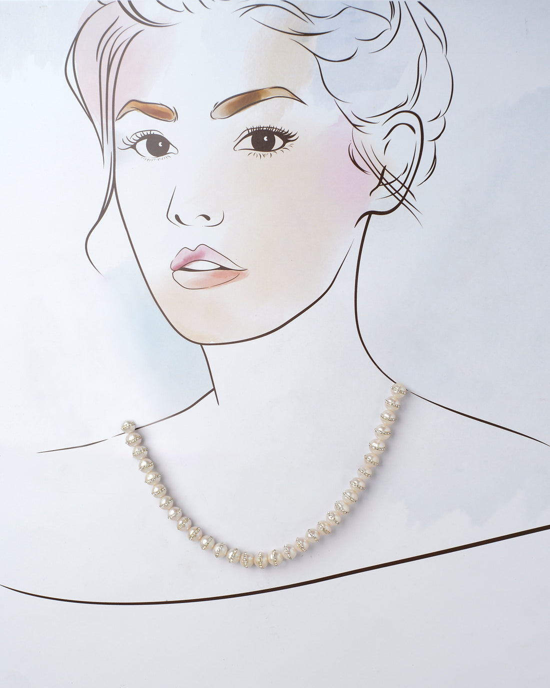 The Velakula-The Coastline Stories Pearl Necklace by Chandrani Pearls, featuring gold and crystal spacer beads, is elegantly showcased on a purple surface.
