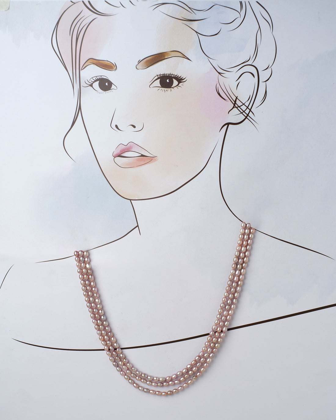 The Udagat - Blushing Rose Pearl Necklace by Chandrani Pearls is elegantly draped over a purple cylinder on a soft pink surface.