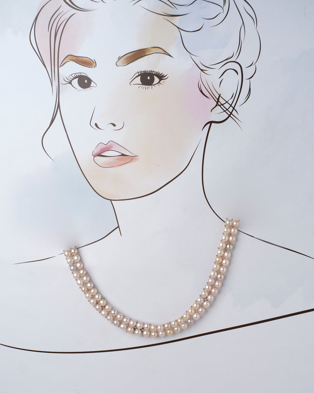 The Lavana-The Coast Memoirs Pearl Necklace by Chandrani Pearls, a luxurious double-stranded piece with pink and white pearls, gracefully drapes over a purple cylinder on a pink surface. Adorned with small white flowers, it is the perfect versatile accessory for any ensemble.