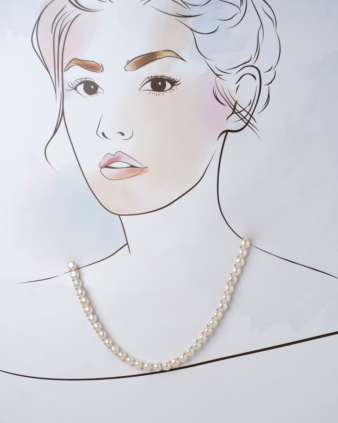 The Smoth Ripple Pearl Necklace by Chandrani Pearls is elegantly displayed with silver accents on a purple and lilac surface.