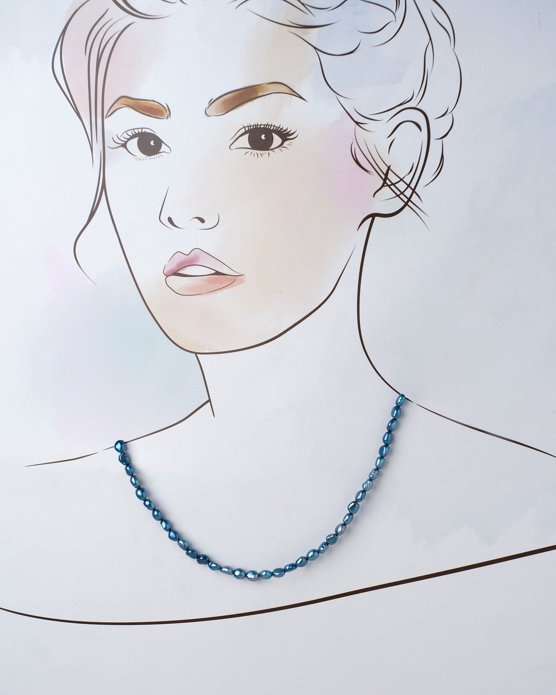 The Syamatva-The Sparkling Night Pearl Necklace by Chandrani Pearls, a timeless accessory, is elegantly displayed on a vibrant purple and pink background with delicate white flowers adding an enchanting touch.