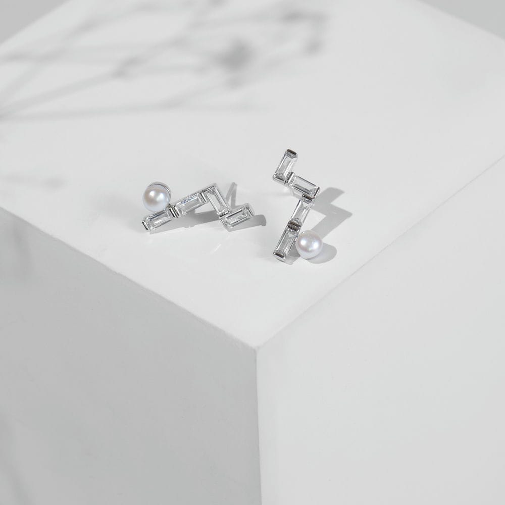 Chandrani Pearls' Minimalist Pearl & CZ Studs feature rectangular cubic zirconia in a zigzag design, each accented with a round freshwater pearl.