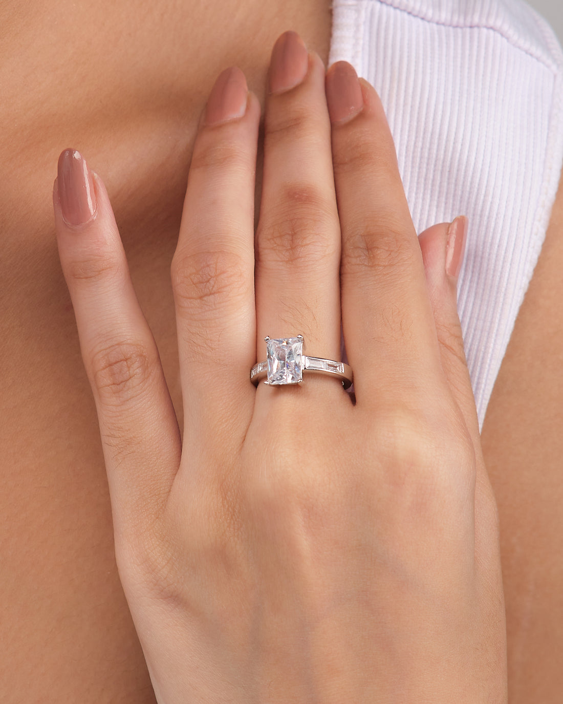 Chandrani Pearls' Classic Demifine Silver Ring with Romantic CZ Center is shown on a white surface, highlighted by a nearby purple satin ribbon.
