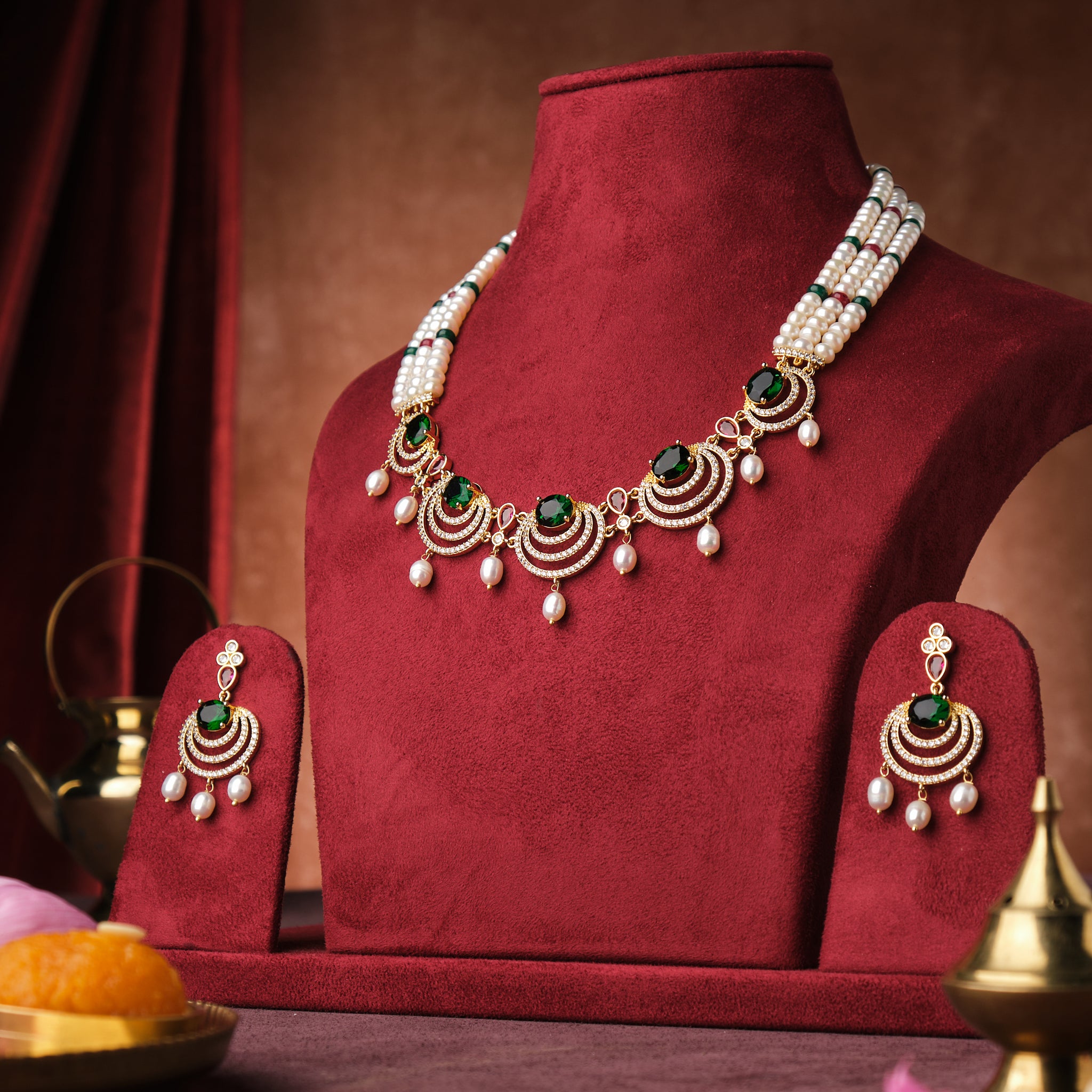 Elegant Glorious CZ Pendant Pearl Necklace Set displayed on a velvet bust with cultural ornaments and decorations by Chandrani Pearls India.